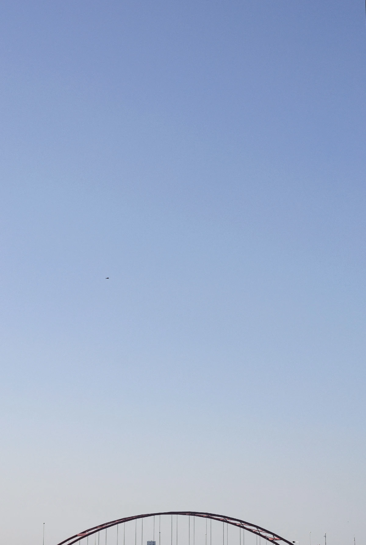 Photo of bridge in Amsterdam with a clear blue sky.