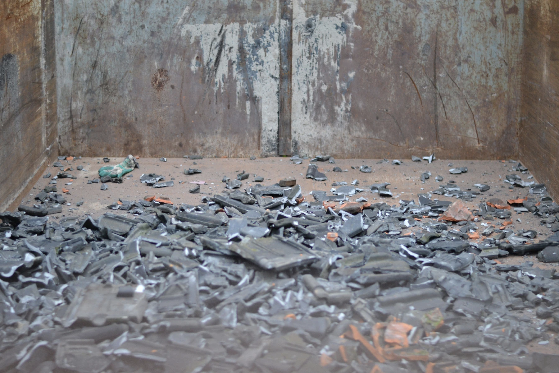 Photo of broken tiles in a container.