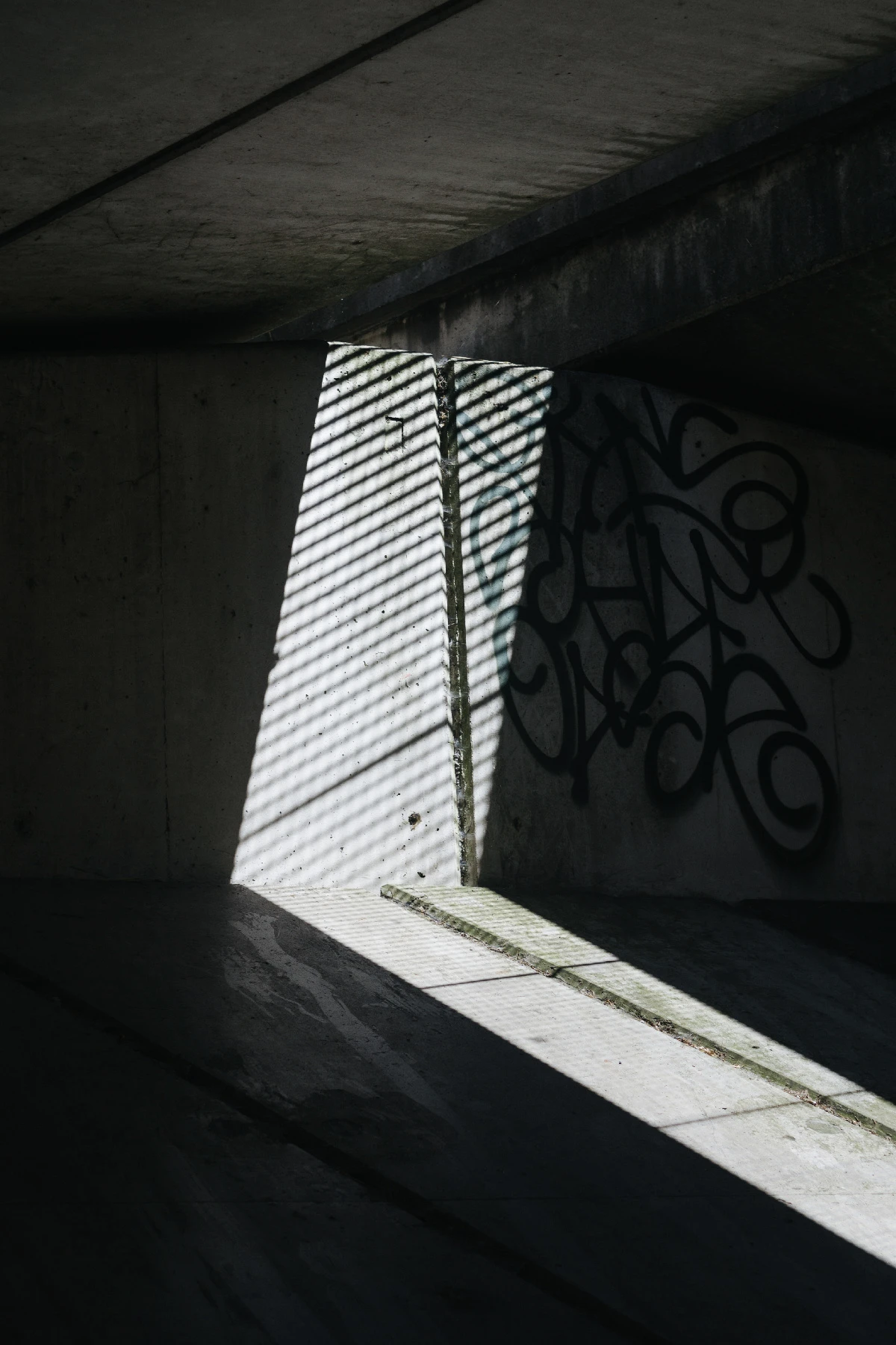Photo of light coming through an underpass situation.