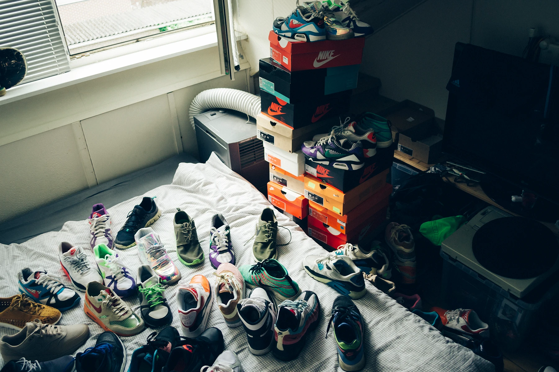 Photo of my old room at my parents' house with a bunch of sneakers I had. Some I still have.